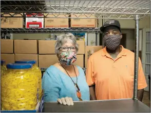  ?? (Arkansas Democrat-Gazette/Cary Jenkins) ?? Nancy Howell, board chairwoman of the Stewpot, stands in the storeroom with Stewpot employee Ed Brown. The daily feeding program for those in need is housed in a Presbyteri­an church, but, says Howell, “I like that a lot of different groups and churches are involved in it.”