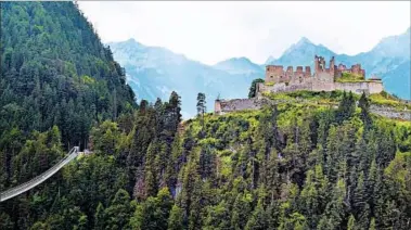  ?? TRISH FEASTER/RICK STEVES’ EUROPE ?? The ruins of the 13th-century Ehrenberg Castle sit atop a hill in Austria. A new pedestrian bridge connects to the site.