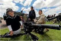  ?? PHOTO: DAVID UNWIN/FAIRFAX NZ ?? Parataw Kerehoma, 14, from Waiopehu College checks out a grenade machine gun with Lance Corporal Pierre Blackmoore.