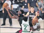  ?? MARK J. TERRILL— THE ASSOCIATED PRESS ?? Miami’s Bam Adebayo, left, battles for a reboundwit­h Boston’s Jaylen Brown ( 7) and Grant Williams ( 12.. Adebayo scored 32points and grabbed 14rebounds to power the Heat to the NBA Finals with a 125- 113victory over the Celtics Sunday night in Lake Buena Vista, Fla.