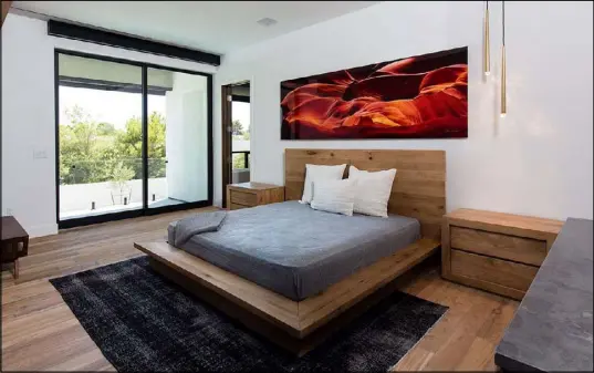  ??  ?? The master bedroom in one of the Jewel Home models features photograph­er Peter Lik’s work. The community is in Las Vegas.