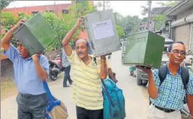  ?? PTI ?? Poll officials carrying ballot boxes ahead of the panchayat polls in North 24 Parganas district of West Bengal on Sunday. The polls will be held on Monday.