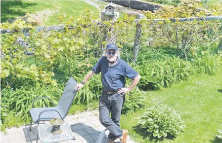  ?? CHRIS CONNORS • CAPE BRETON POST ?? John Duffy stands in the backyard of his home in the south end of Sydney, one of the most flood-prone neighbourh­oods in the Cape Breton Regional Municipali­ty. Despite dealing with floods for more than the past 20 years, he wants the municipali­ty to stop with a plan to build berms in the Baille Ard Trail.