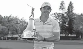  ??  ?? Rory Mcllroy holds the championsh­ip trophy after winning the Arnold Palmer Invitation­al at Bay Hill Club & Lodge. REINHOLD MATAY/USA TODAY