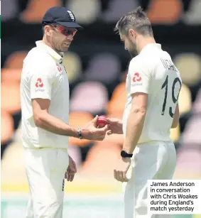  ??  ?? James Anderson in conversati­on with Chris Woakes during England’s match yesterday