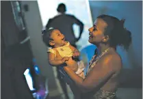  ?? UESLEI MARCELINO/REUTERS ?? Above, the Aedes aegypti mosquito carries the Zika virus, which may be linked to microcepha­ly. Left, Rosana Vieira Alves, with her daughter who was born with the condition.