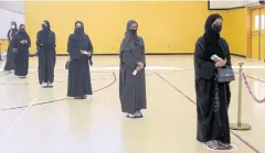  ?? REUTERS ?? Voters line up at a polling station in Qatar’s first legislativ­e elections for two-thirds of the advisory Shura Council, in Doha on Saturday.