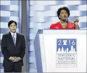  ?? CAROLYN KASTER / ASSOCIATED PRESS ?? Georgia House Minority Leader Stacey Abrams speaks as California state Sen. Kevin de Leon watches during the first day of the Democratic National Convention on Monday.