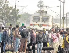  ?? ANI ?? Protesters stop a train in Patna on Tuesday. Crowds came out on the streets in various parts of the state as soon as the news of the woman’s death spread.