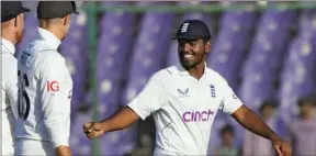  ?? PIC: FAREED KHAN/AP ?? England’s Rehan Ahmed is all smiles as he walks off the field after taking five wickets in Pakistan’s second innings in the third Test
