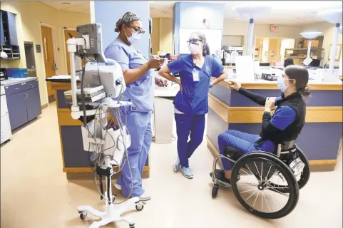  ?? Arnold Gold / Hearst Connecticu­t Media ?? Registered nurse Lindsey Runkel, right, speaks with patient care associate Sephora Tompkins, left, and registered nurse Amy Smith at Yale New Haven Hospital on Tuesday.