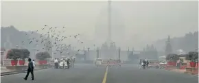  ??  ?? Buildings are seen shrouded in smog in New Delhi, India, November 8, 2018.