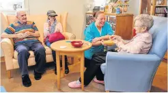  ?? ?? Cosy Residents Alex Matthews, Iris Temple and Hannah McGregor enjoying a drink and a chat in Jenny’s Bar