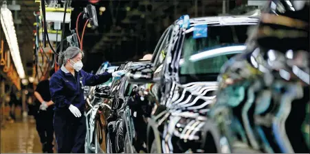  ?? PHOTOS PROVIDED TO CHINA DAILY ?? Workers inspect finished vehicles on the production line at the Beijing Benz’s plant in February.