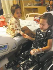  ?? Courtesy Avery family ?? Four-year-old Noah Avery (left) holds hands with his sister, Kalea, 6, at the hospital in Long Beach.