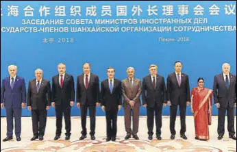  ?? AFP PHOTO ?? Foreign minister Sushma Swaraj (second from right) poses for a group photo with her counterpar­ts and other officials before a meeting at the Diaoyutai State Guest House in Beijing on Tuesday.