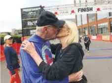  ?? Helen H. Richardson, The Denver Post ?? Fred Berhenke and Suzy Whittemore, both 73, kiss Sunday after they finished the 5-mile race at the 35th annual Cherry Creek Sneak in Denver.