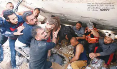  ?? REUTERSPIX ?? Rescuers carrying a girl to safety as they search for victims amid rubble at the site of Israeli air strikes in Gaza City yesterday. –