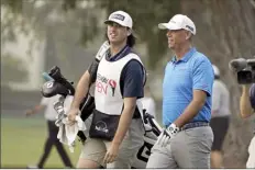  ?? AP file photo ?? Stewart Cink (right) walks with his caddie and son, Reagan Cink, during the Safeway Open.