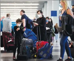  ?? (File Photo/AP/Nam Y. Huh) ?? Travelers line up July 2 at O’Hare airport in Chicago.