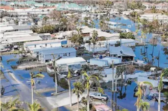  ?? Steve Helber / Associated Press ?? A trailer park in Fort Myers, Fla., remains inundated days after Hurricane Ian raked the region and caused broad flooding. Ian is expected to be one of the costliest hurricanes in U.S. history.