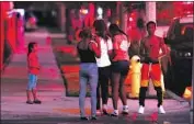  ?? Myung J. Chun Los Angeles Times ?? PEOPLE watch from the street as authoritie­s search for a shooter near the Lancaster sheriff’s station.