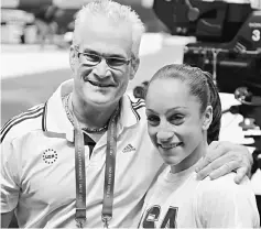  ?? — AFP photo ?? This file photo taken on October 13, 2011 shows US gymnast Jordyn Wieber (right) celebratin­g her victory with her coach John Geddert in the women’s all-around final at the World Gymnastics Championsh­ips in Tokyo.