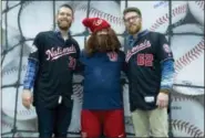  ?? AP PHOTO — JOSE LUIS MAGANA ?? Washington Nationals pitchers Stephen Strasburg, left and Sean Doolittle, take their picture with fan Tracy Tran during the Winter Fest celebratio­n with fans at Washington Convention Center in Washington, Saturday.