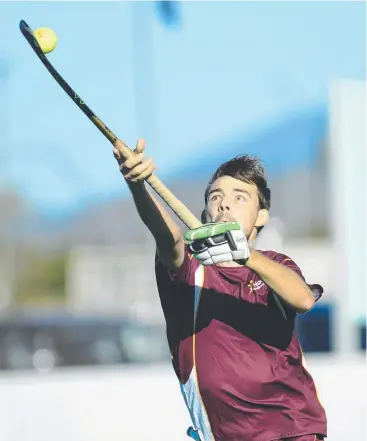  ??  ?? HANDY ACCESSORY: Peter Sceresini with his cricket glove in action for Queensland Country against Victoria Country in the Australian Country Hockey Championsh­ips.