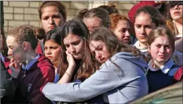  ?? The Associated Press ?? Students from the Yeshiva School in the Squirrel Hill neighbourh­ood of Pittsburgh stand outside Beth Shalom Synagogue after attending the funeral service for Joyce Fienberg on Wednesday. Fienberg, 75, was one of 11 people killed when a gunman opened fire during worship services Saturday at the Tree of Life Synagogue.