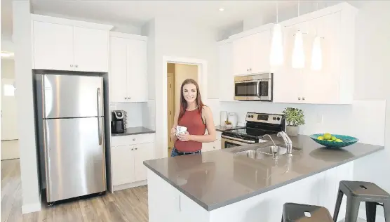  ?? WIL ANDRUSCHAK ?? Carly Goheen in the kitchen of the Monarch XL duplex by Slokker Homes in Georgetown at Reunion in Airdrie.