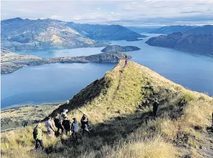  ?? PHOTO: SUPPLIED ?? View from the top . . . Comedian and leader of the fictional ‘‘Social Observatio­n Squad’’ Tom Sainsbury is filmed on Wanaka’s Roys Peak recently.