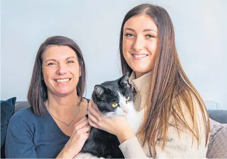  ??  ?? Denise, left, and daughter Macy Harbut with Baxter.