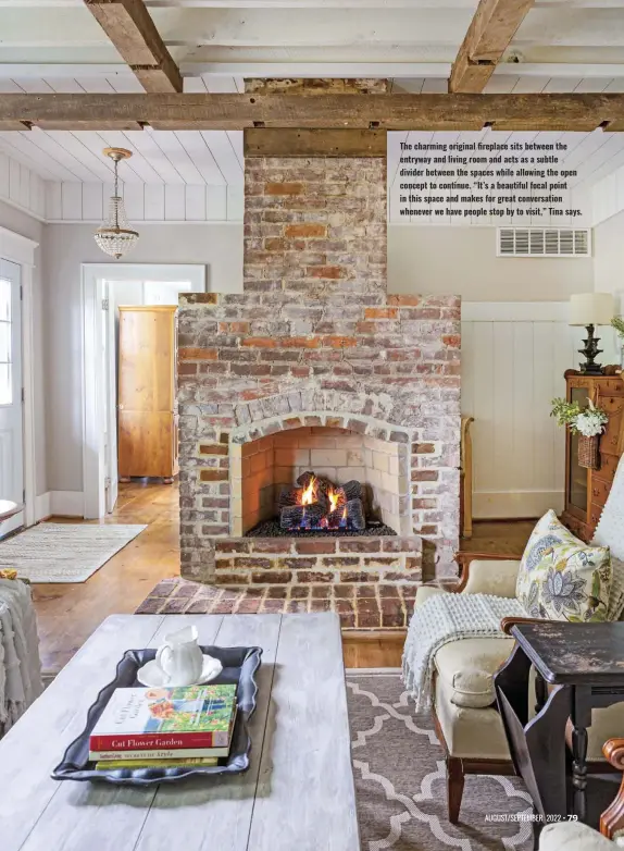  ?? ?? The charming original fireplace sits between the entryway and living room and acts as a subtle divider between the spaces while allowing the open concept to continue. “It’s a beautiful focal point in this space and makes for great conversati­on whenever we have people stop by to visit,” Tina says.