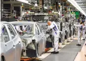  ?? Reuters ?? Unlike Italy and Spain, Germany did not ban car production, but factories stopped after car dealership­s were closed.