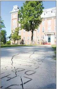  ?? NWA Democrat-Gazette/DAVID GOTTSCHALK ?? Cracks are visible in this section of the Senior Walk outside Old Main on the University of Arkansas, Fayettevil­le, campus. A plan to replace crumbling concrete sections of the sidewalk received a $150,000 boost from a state grant approved earlier this month, but no start date has been set for the project.