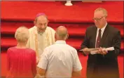  ?? Photo by Becky Polaski ?? Bishop Lawrence T. Persico presents Mr. and Mrs. James Iannuzzi Jr. with a scroll in honor of their 60th wedding anniversar­y during a Milestone Anniversar­y Celebratio­n Mass held at St. Mary’s Church in St. Marys on Sunday afternoon.