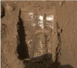  ??  ?? A trench dug out by Phoenix’s robot arm which scientists believe reveals buried ice