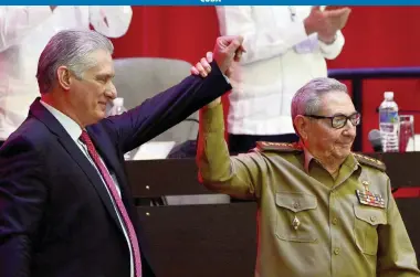  ?? ARIEL LEY ROYERO Cuban state media via AP ?? Raúl Castro, right, raises the hand of Cuban President Miguel Díaz-Canel after Díaz-Canel was named first secretary of the Communist Party at the closing of the party's Congress in Havana on Monday.