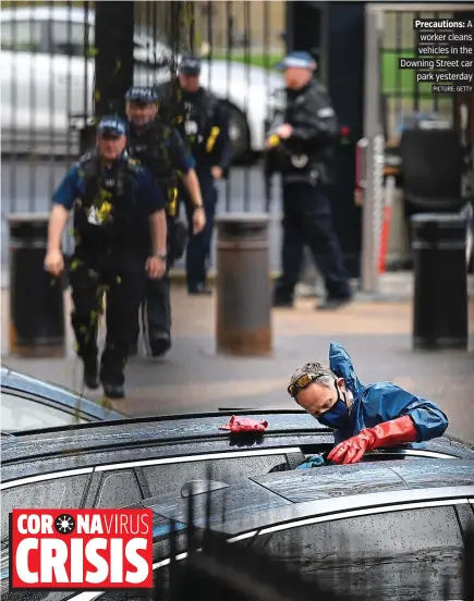  ?? PICTURE: GETTY.. ?? Precaution­s: A worker cleans vehicles in the Downing Street car park yesterday.