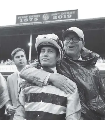  ?? JAMIE SQUIRE Getty Images ?? Jockey Flavien Prat celebrates after Country House won the 145th running of the Kentucky Derby at Churchill Downs on a disqualifi­cation. The stunning outcome gave Hall of Fame trainer Bill Mott his first Derby victory at age 65.