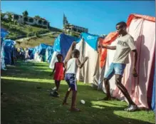  ?? ODELYN JOSEPH / ASSOCIATED PRESS ?? Children play at the Devirel camp in Les Cayes, Haiti, on Feb 16. The internatio­nal community has pledged $600 million to help rebuild Haiti’s devastated south, where an earthquake killed more than 2,200 people six months ago.