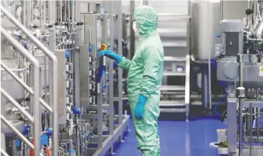  ?? CHINA OUT / STRINGER / REUTERS ?? A technician works at a manufactur­ing facility of vaccine maker Cansino Biologics in Tianjin, China.