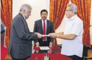  ?? ?? Sri Lanka’s Prime Minister Ranil Wickremesi­nghe (L) sworn in as the new finance minister, in Colombo, May 25, 2022.