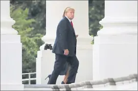  ?? MANUEL BALCE CENETA — THE ASSOCIATED PRESS ?? President Donald Trump and first lady Melania Trump walk on the North Portico as they arrive back to the White House in Washington on Sunday.