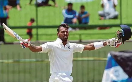  ?? AFP PIC ?? India’s Hardik Pandya raises his bat and helmet in celebratio­n after scoring a century during the second day of the Third Test against Sri Lanka yesterday.