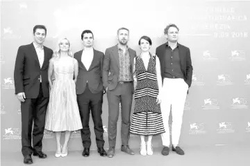  ?? — Reuters photo ?? Director Damien Chazelle (third left), screenwrit­er Josh Singer (extreme left) and cast members Ryan Gosling (third right), Jason Clarke, Olivia Hamilton and Claire Foy (second right) during a photocall for the opening movie ‘First Man’ competing in the Venezia 75 section in Venice, Italy, end of last month.