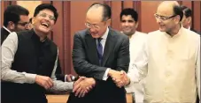  ?? TASHI TOBGYAL ?? World Bank president Jim Yong Kim (C) shakes hands with power minister Piyush Goyal (left) and finance minister Arun Jaitley, in New Delhi on Thursday
