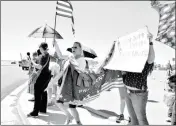  ?? Buy this photo at YumaSun.com PHOTO BY RACHEL TWOGUNS/YUMA SUN ?? TRUMP SUPPORTERS CONVENE at the corner of 32nd Street and Avenue 2 1/2 E before his arrival to Yuma on Tuesday.