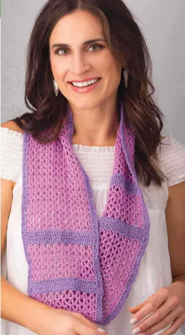  ??  ?? Simply crochet alternatin­g bands of V-stitches and double crochet in your favorite colors and you’ll find yourself wearing this pretty scarf often! Our version is crocheted in a pretty cotton and silk blend, but this would be just as useful made in a...